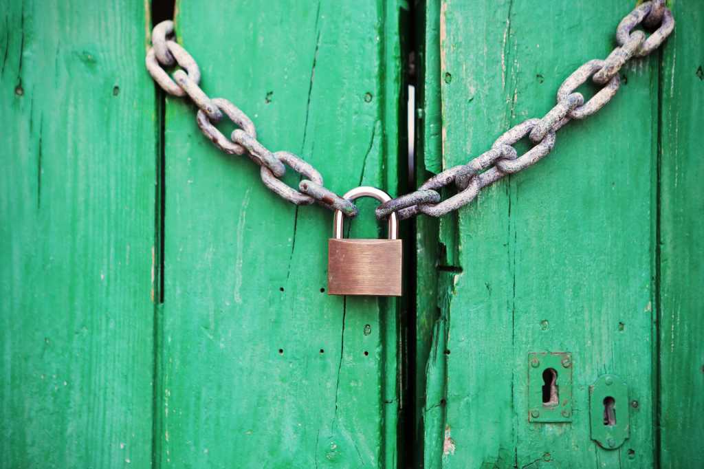 green doors with padlock and chains